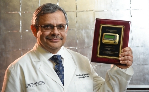 Dr. Venkatesh Aiyagari holding Golden Pager award