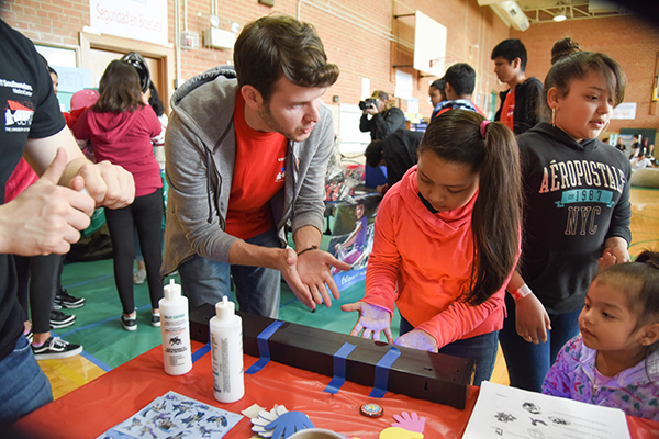 Nine-year-old Estrella Martinez, who visited the “Superheroes” booth, met medical student Cooper Hale.