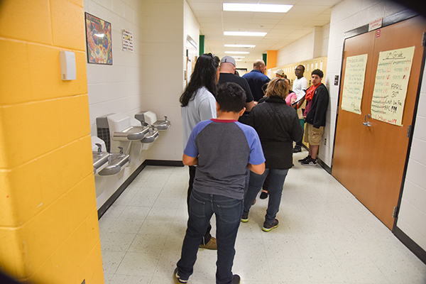 Attendees head to the screening area where blood pressure, glucose levels, and other vital statistics are checked