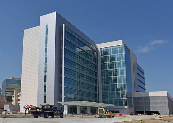 West Campus Building 3 exterior with some construction vehicles parked outside