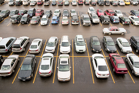 Cars in parking lot with one empty parking spot