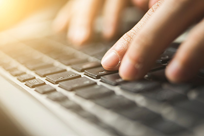 Fingers on a laptop keyboard