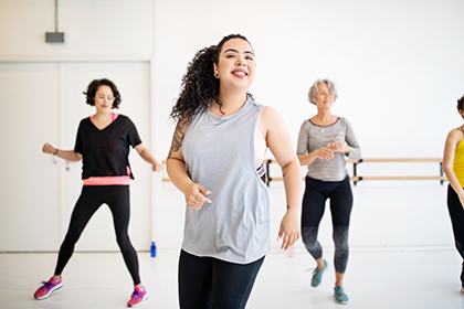 Three women dance in a room