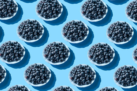 Blueberries in bowls against a bright background