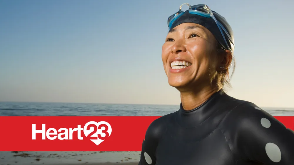 Heart 23 with a woman wearing swimming goggles and smiling