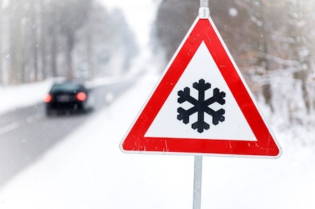 A triangular street sign with a snowflake on it