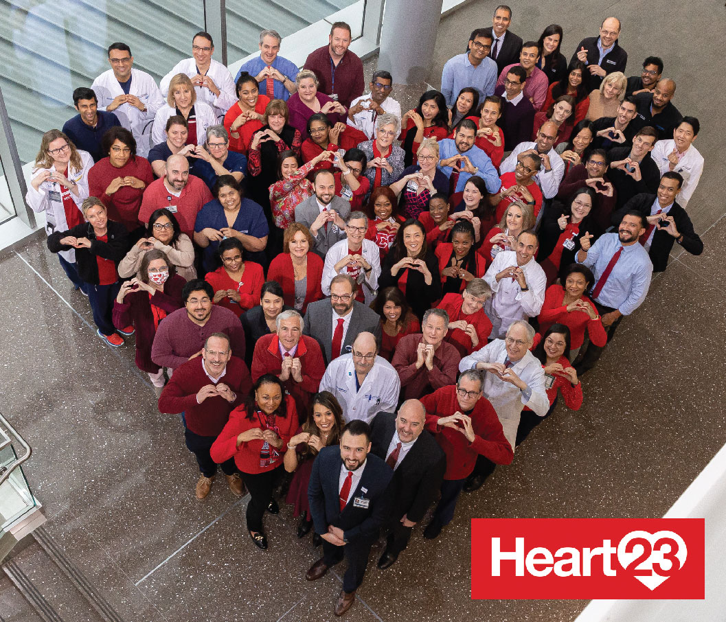 A group of people stand in the shape of a heart